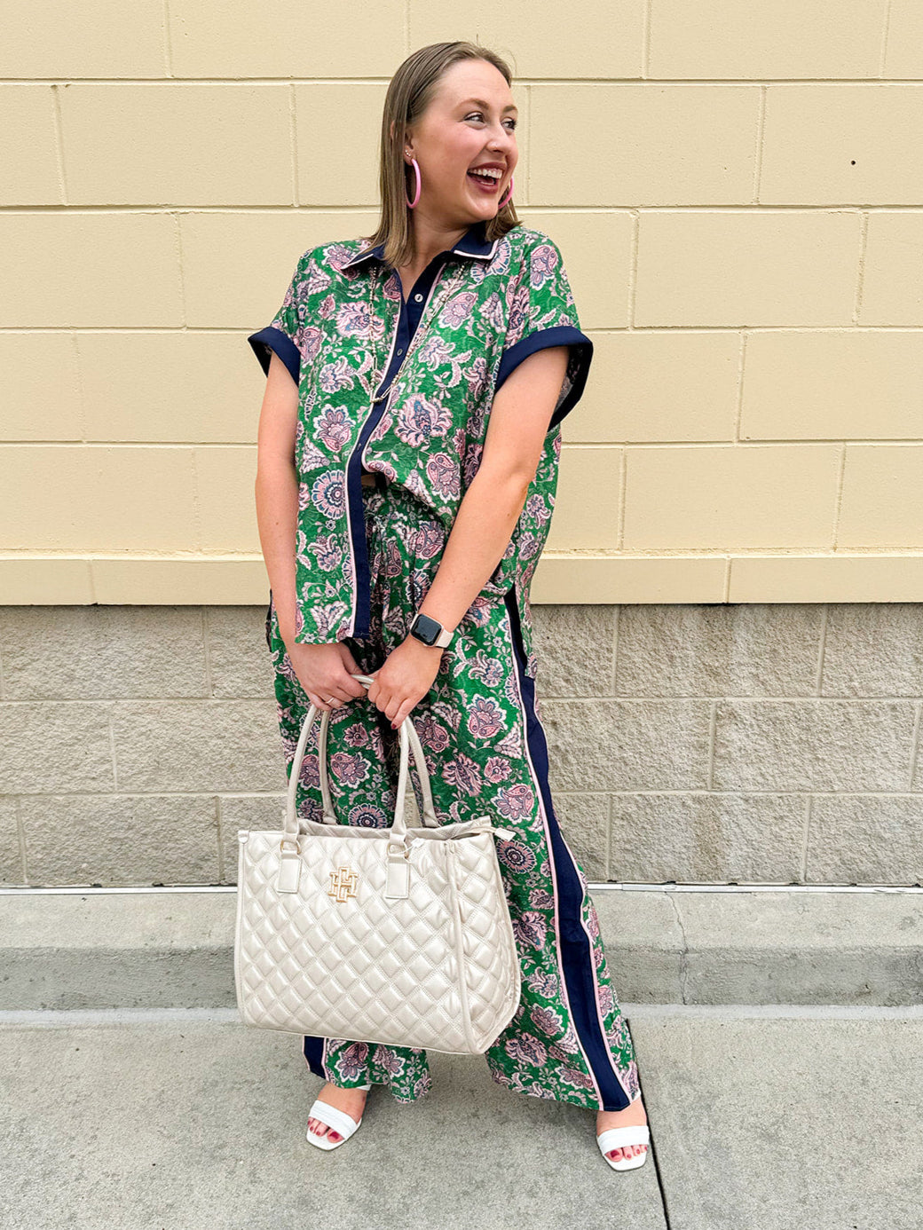 Floral paisley button-down blouse with navy collar, pink trim, high-low hem, and navy-trimmed sleeves—lightweight and chic