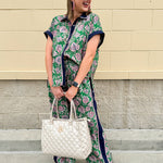 Floral paisley button-down blouse with navy collar, pink trim, high-low hem, and navy-trimmed sleeves—lightweight and chic