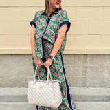 Floral paisley button-down blouse with navy collar, pink trim, high-low hem, and navy-trimmed sleeves—lightweight and chic