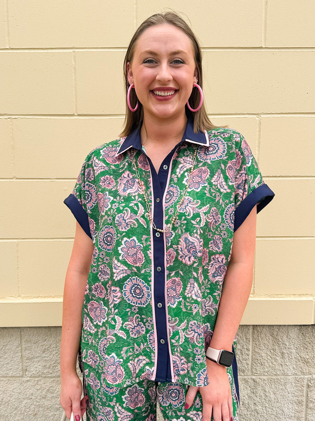 Floral paisley button-down blouse with navy collar, pink trim, high-low hem, and navy-trimmed sleeves—lightweight and chic