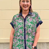 Floral paisley button-down blouse with navy collar, pink trim, high-low hem, and navy-trimmed sleeves—lightweight and chic