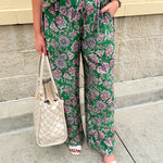 Floral paisley button-down blouse with navy collar, pink trim, high-low hem, and navy-trimmed sleeves—lightweight and chic