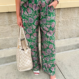 Floral paisley button-down blouse with navy collar, pink trim, high-low hem, and navy-trimmed sleeves—lightweight and chic