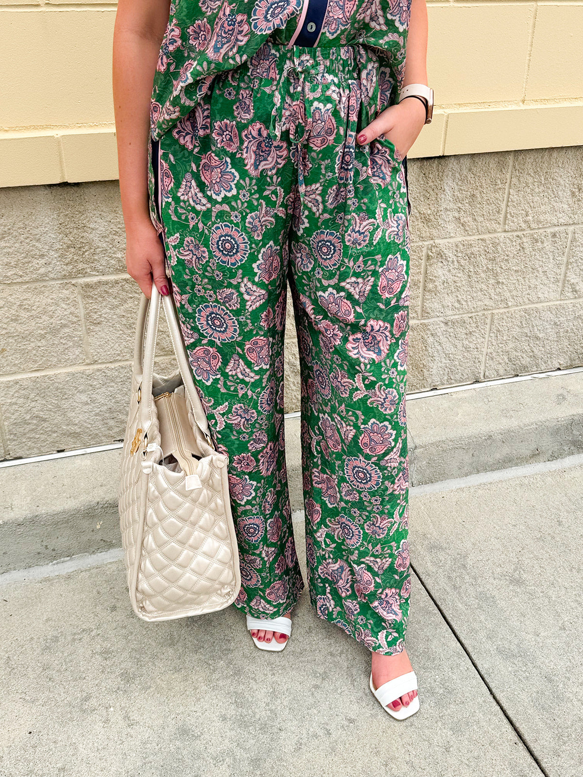 Floral paisley button-down blouse with navy collar, pink trim, high-low hem, and navy-trimmed sleeves—lightweight and chic
