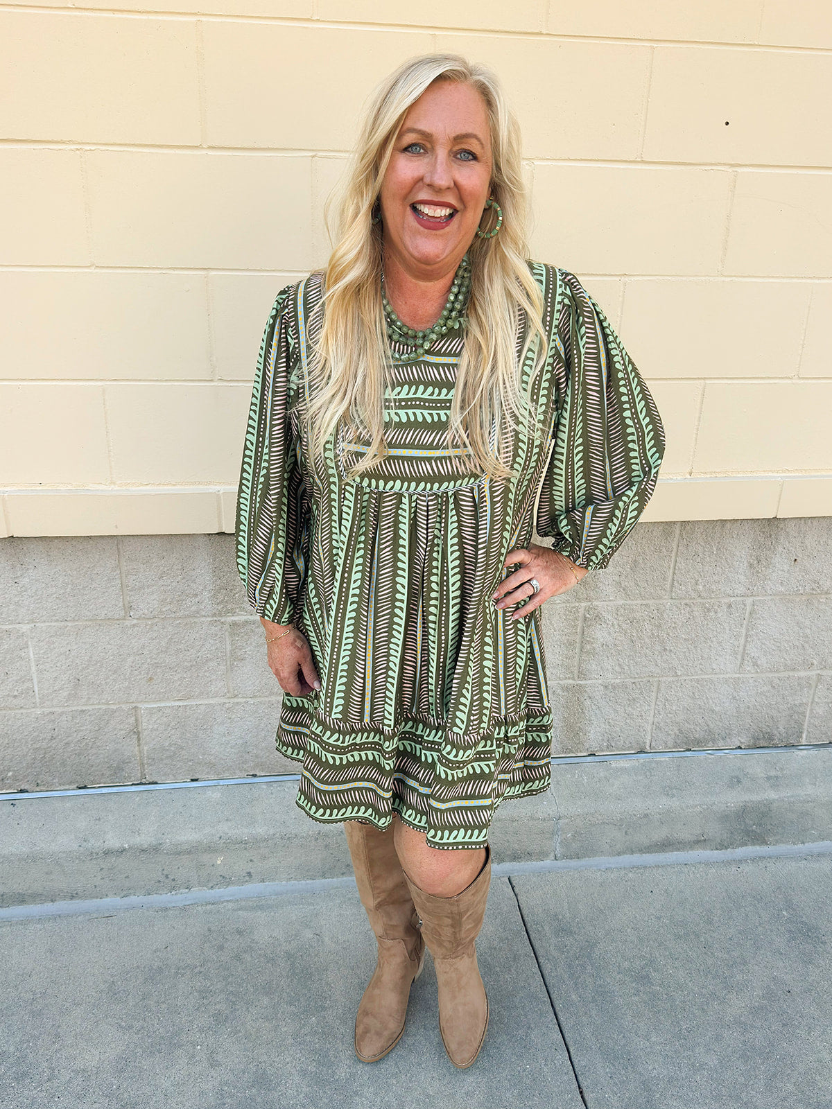Olive mini dress with ruffled hem, striped trim, and pink/green earthy design