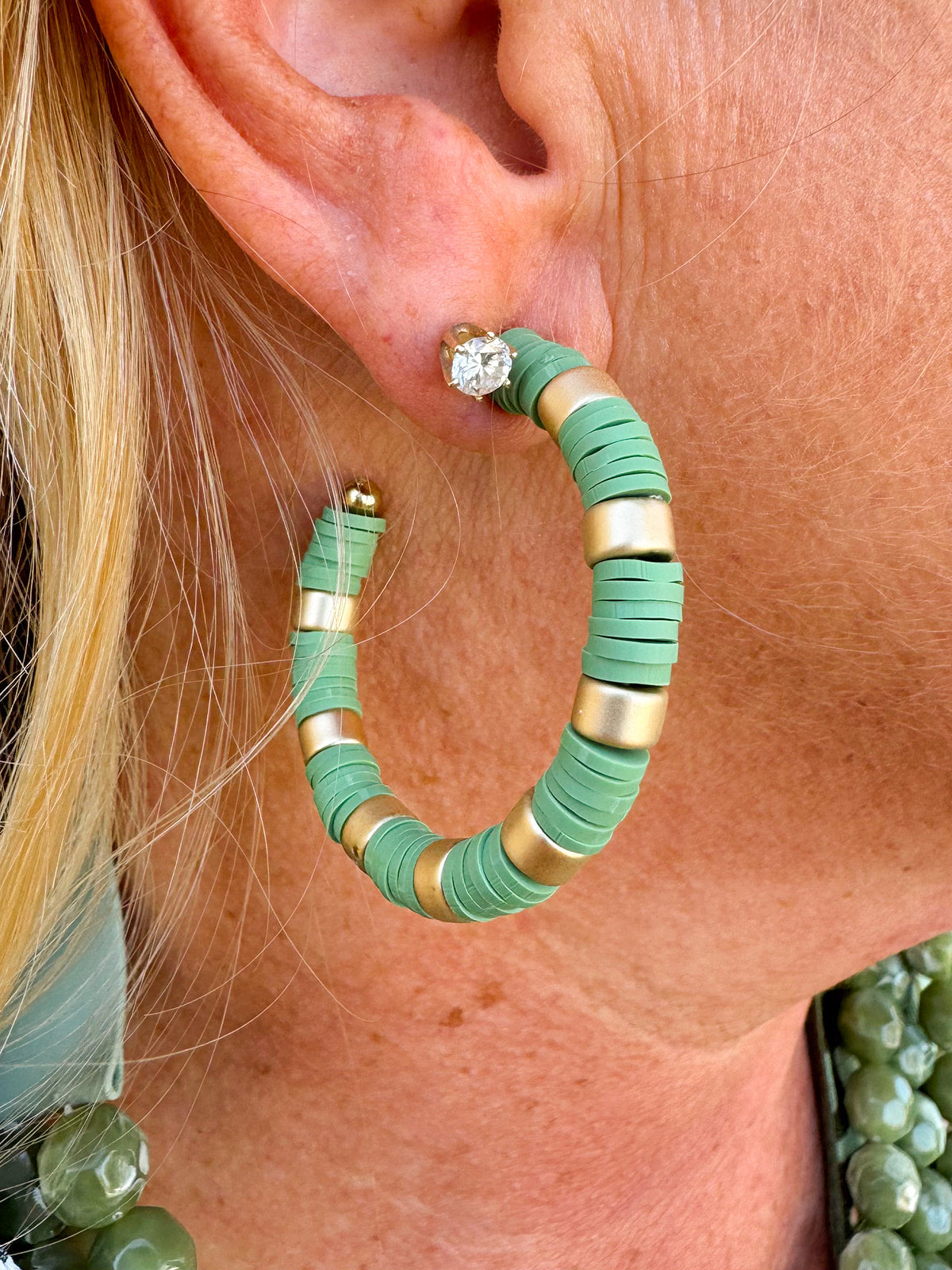 Olive green and gold statement earrings featuring a mix of rubber and metal—lightweight, bold, and fashion-forward.