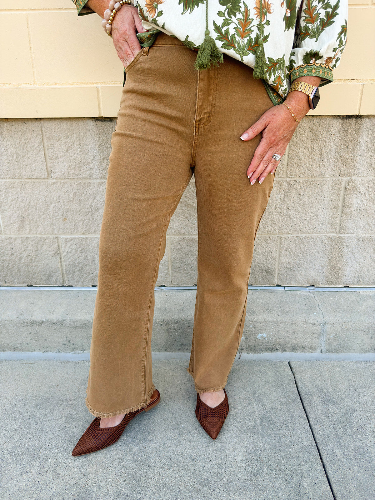 Deep camel acid-washed high-waisted bootcut pants with frayed hem.
