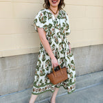 Olive, cream, and bronze floral midi dress with scalloped sleeves, covered buttons, and empire waistline.