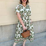 Olive, cream, and bronze floral midi dress with scalloped sleeves, covered buttons, and empire waistline.