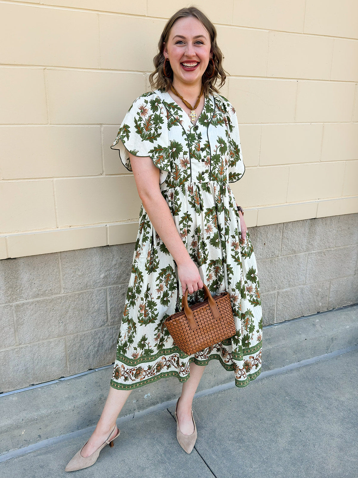 Olive, cream, and bronze floral midi dress with scalloped sleeves, covered buttons, and empire waistline.