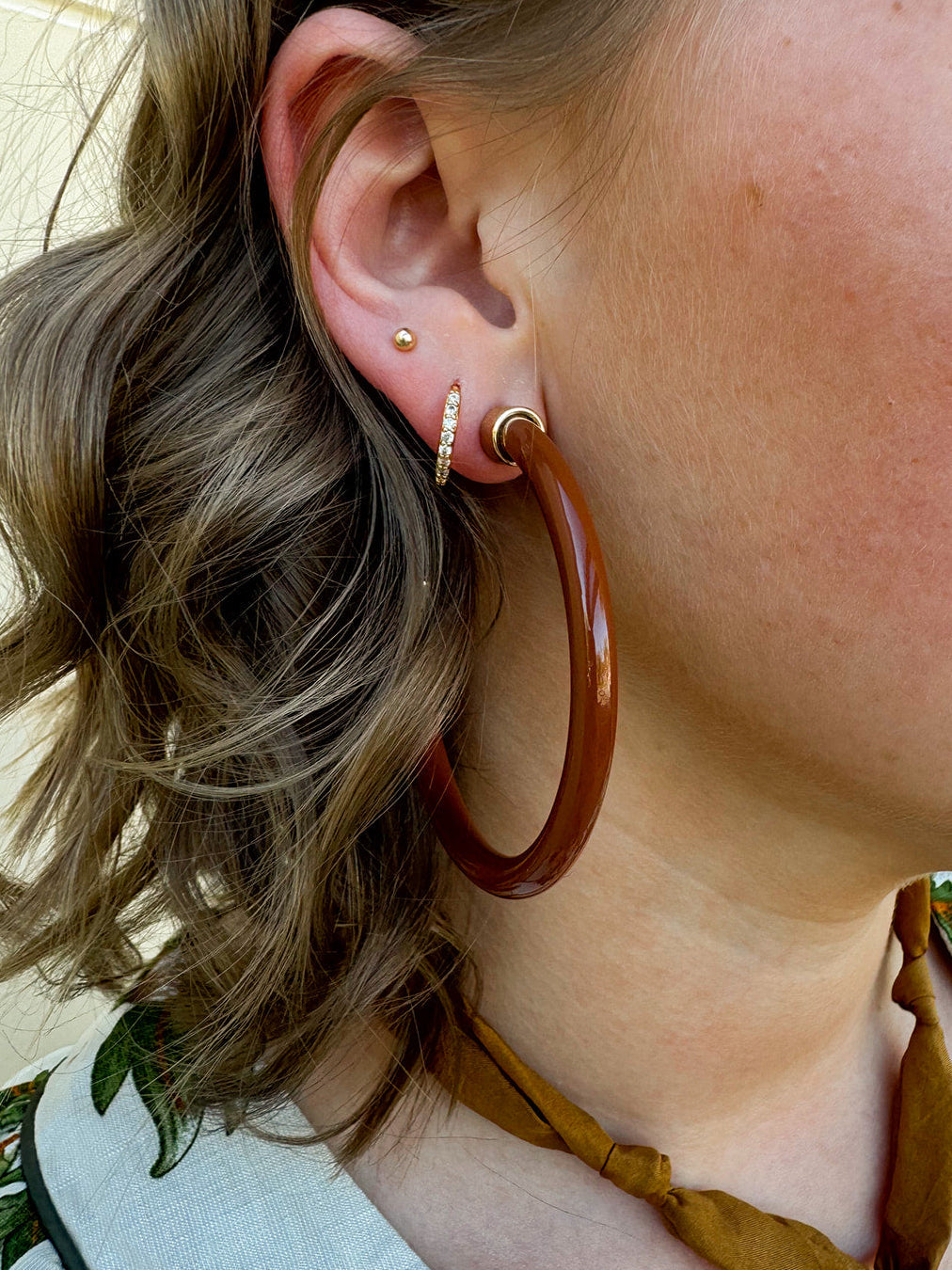 Café brown 2” acrylic hoop earrings with lightweight, hypoallergenic design.