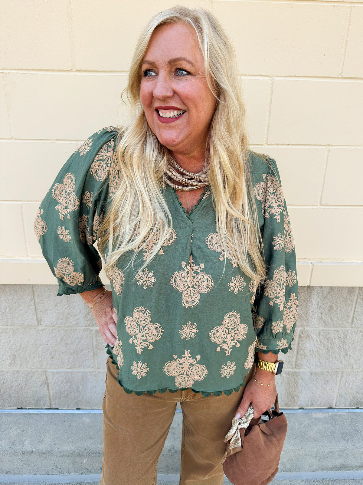 Olive printed V-neck blouse with ¾ puff sleeves and ric-rac trim detailing.