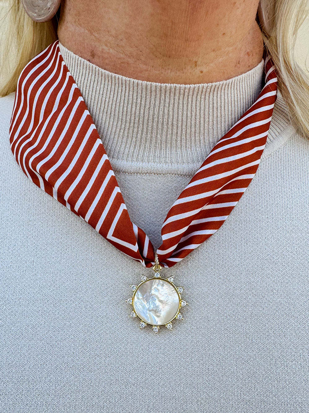Rust and cream striped scarf necklace with pearl-inspired resin sun charm, handmade by Hart Designs.