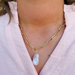 Bright gold-tone paperclip chain necklace with baroque freshwater pearl pendant from Sorrelli’s Modern Pearl Collection.