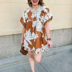 Bronze and cream babydoll mini dress with ruffled neckline, puff sleeves, and striped piping detail.