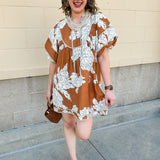 Bronze and cream babydoll mini dress with ruffled neckline, puff sleeves, and striped piping detail.