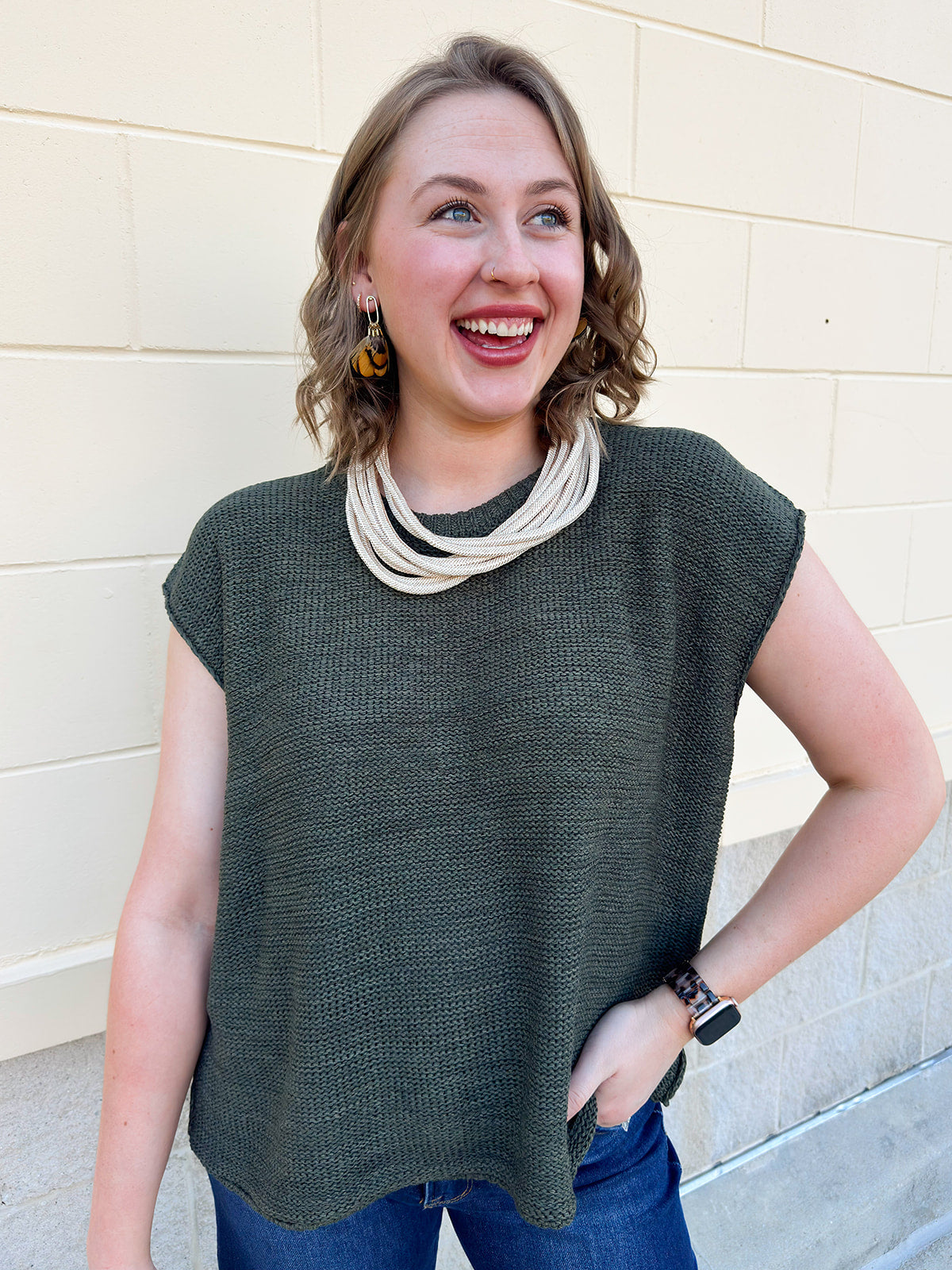 Dark olive oversized short-sleeve crew neck sweater with drop shoulder and side slits.