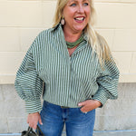 Sage green and cream striped oversized button-down top with collared neckline and pirate-style long sleeves.
