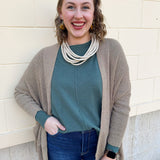 Camel knit cardigan with long sleeves, front pockets, and open front.