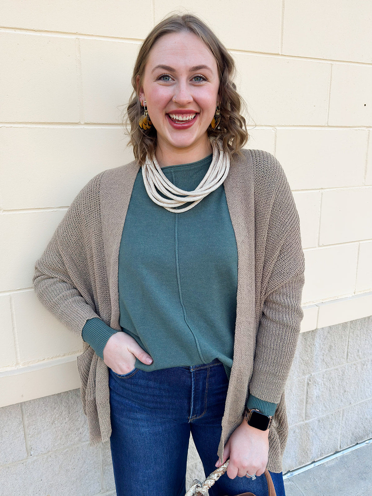 Camel knit cardigan with long sleeves, front pockets, and open front.