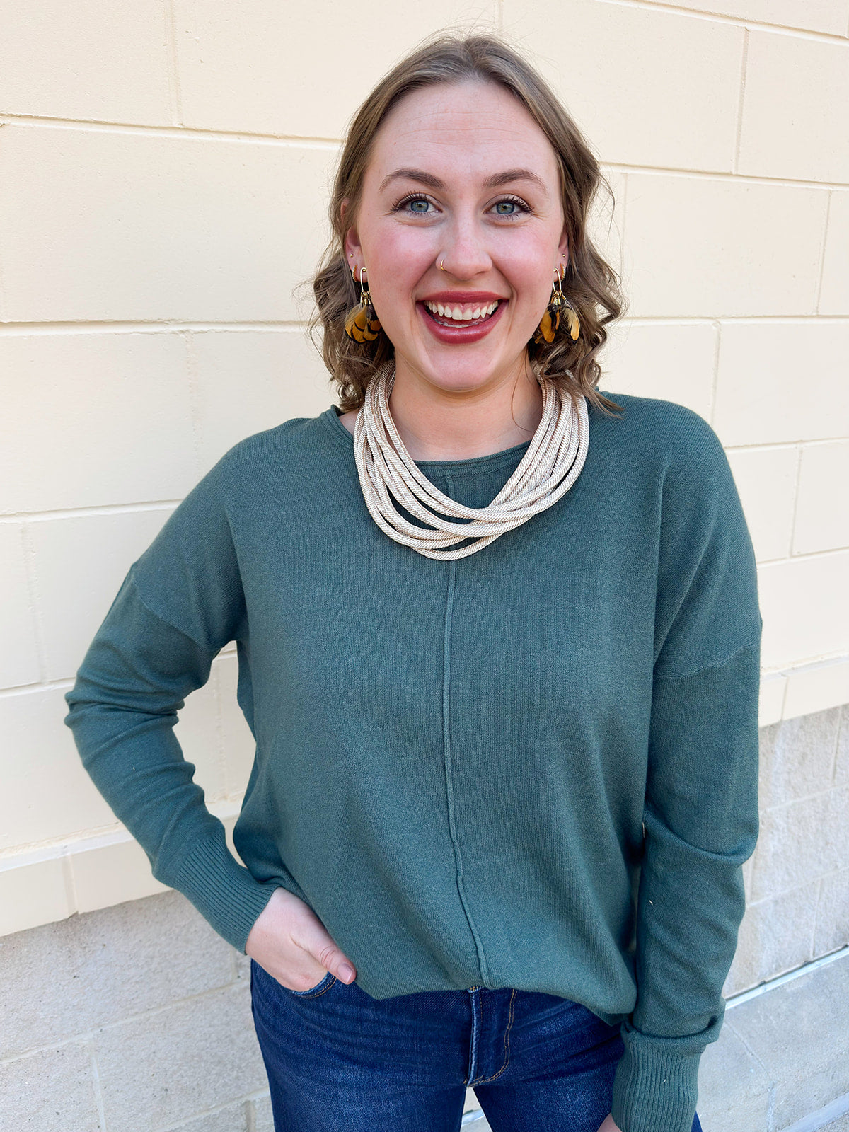 Sage green round neck knit sweater with front seam detail