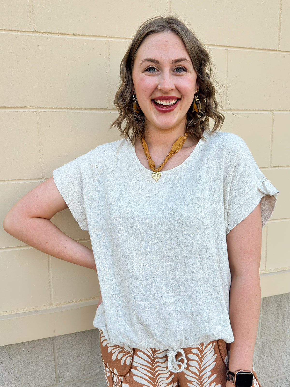 linen short sleeve top with tie detailing at the bottom.