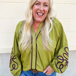 Chartreuse blouse with garnet soutache embroidery, V-neckline, and pirate-style long sleeves with elastic cuffs.