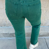 Emerald green high-waisted bootcut pants with a subtle flare and frayed hem.