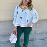 Emerald green high-waisted bootcut pants with a subtle flare and frayed hem.