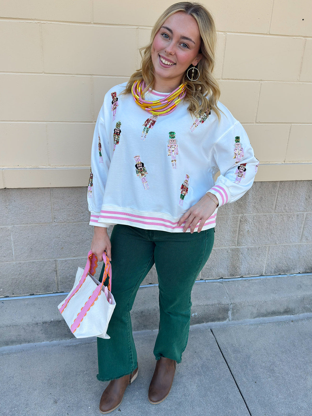 Emerald green high-waisted bootcut pants with a subtle flare and frayed hem.