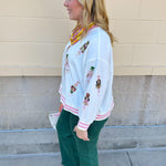 Emerald green high-waisted bootcut pants with a subtle flare and frayed hem.