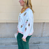 Emerald green high-waisted bootcut pants with a subtle flare and frayed hem.