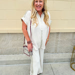 Oatmeal wide leg pants with gold side piping and drawstring waist