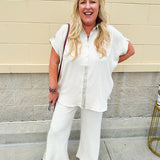 Oatmeal wide leg pants with gold side piping and drawstring waist