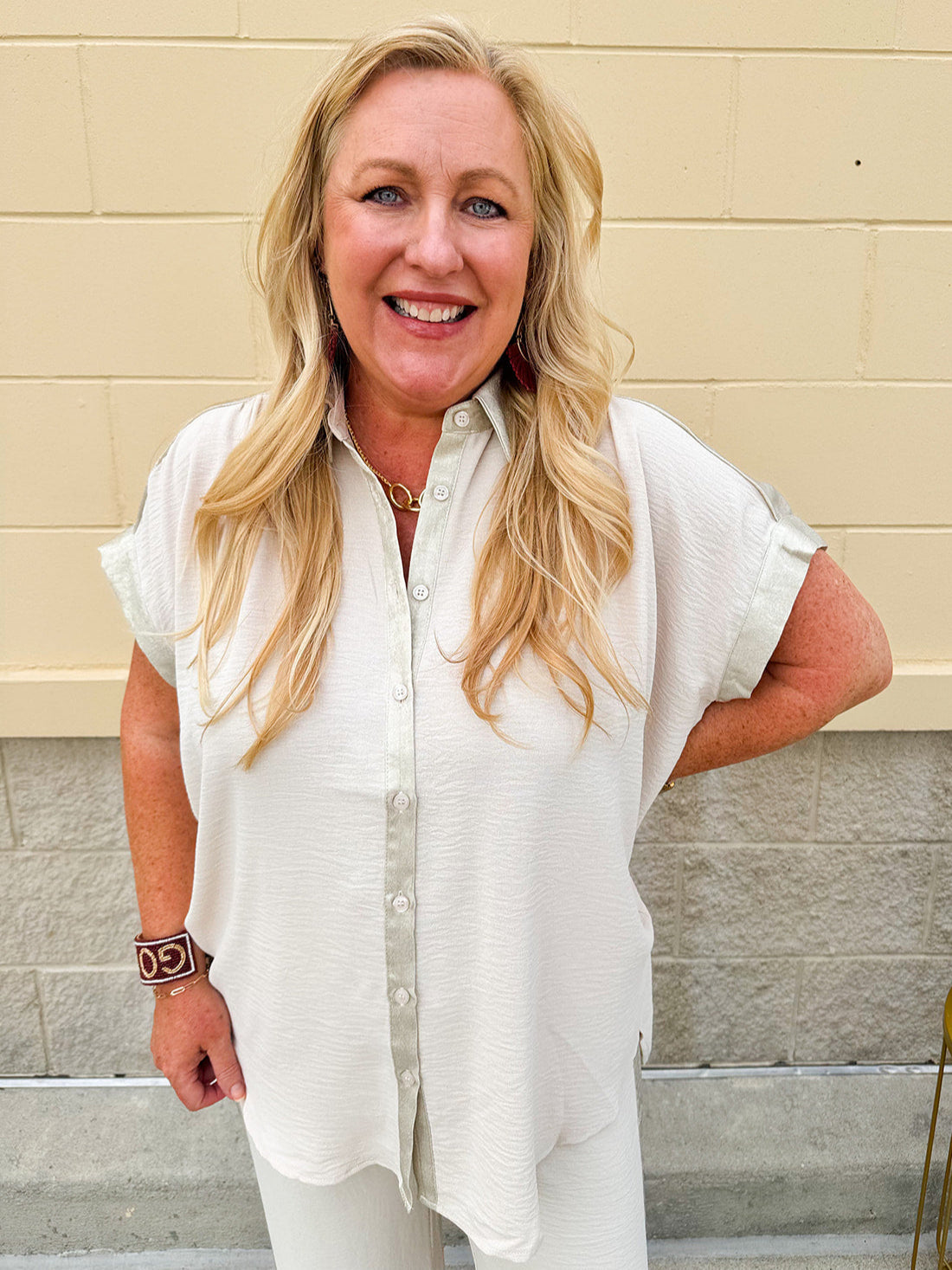 Oatmeal button-down top with gold trim, relaxed fit