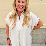 Oatmeal button-down top with gold trim, relaxed fit