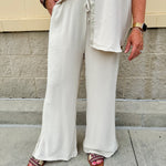 Oatmeal wide leg pants with gold side piping and drawstring waist