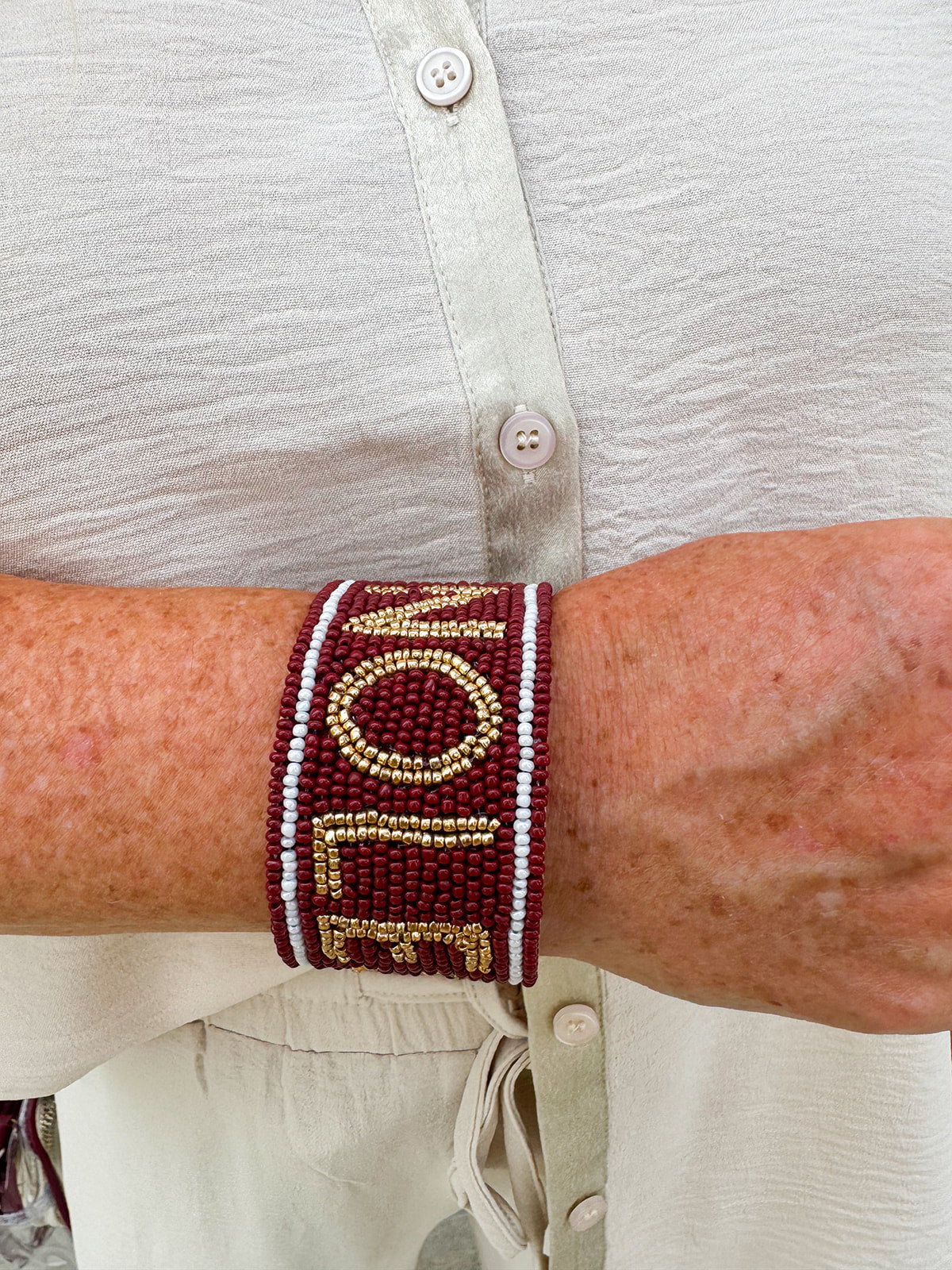Garnet and gold beaded cuff bracelet featuring the FSU logo, perfect for showing team spirit.