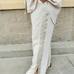 Oatmeal wide leg pants with gold side piping and drawstring waist