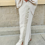 Oatmeal wide leg pants with gold side piping and drawstring waist