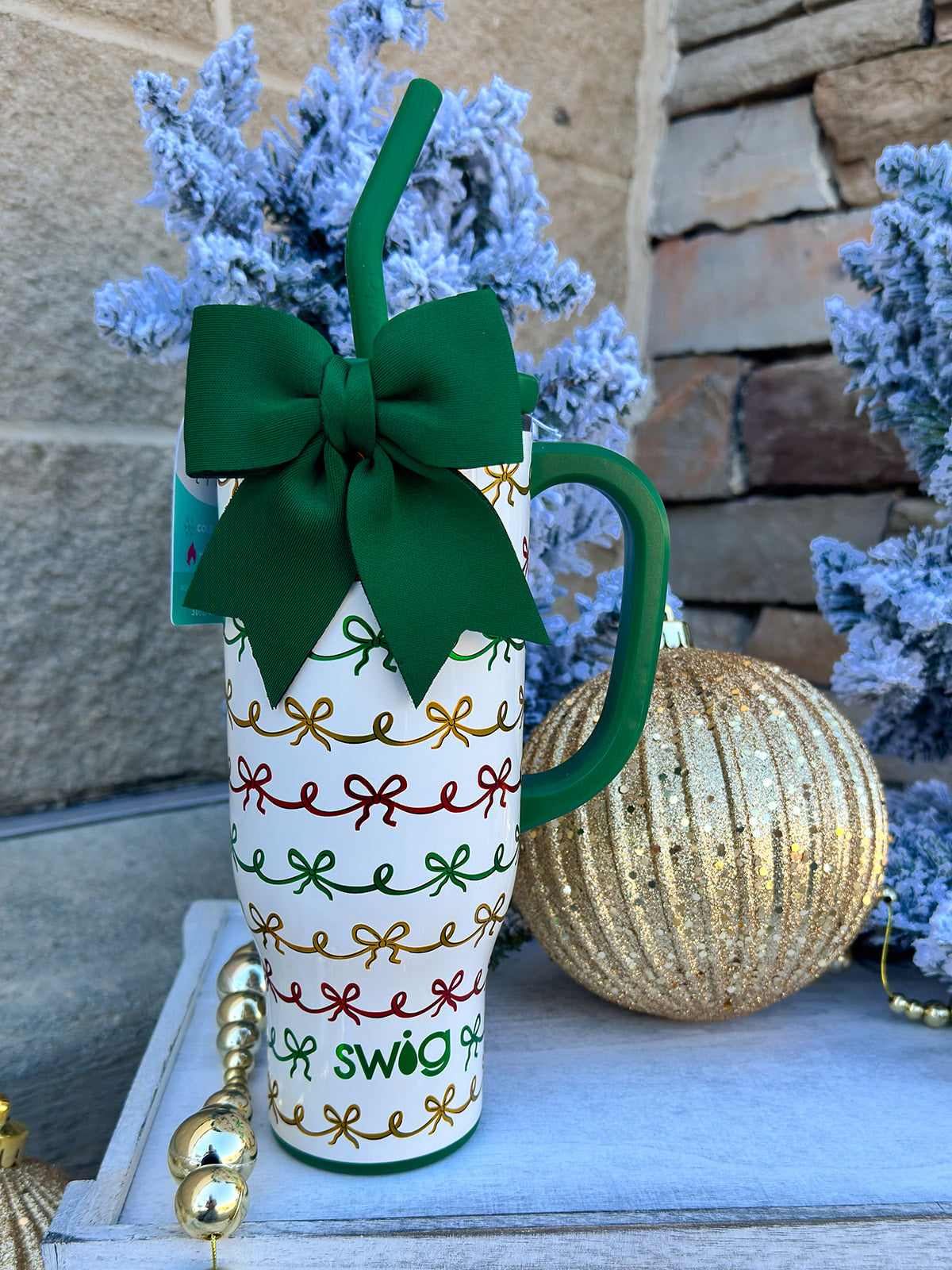 Ivory glitter 30oz insulated mug with red, green, and gold metallic bows and removable bow accent.