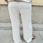Oatmeal wide leg pants with gold side piping and drawstring waist
