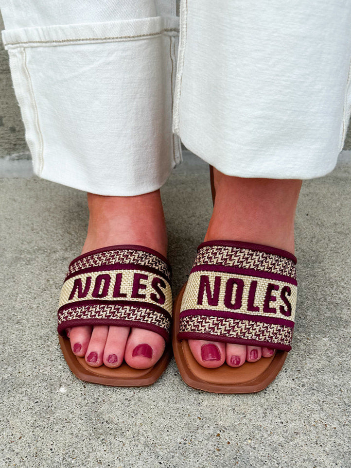 Gold slip-on sandals with garnet “Noles” embroidery and patterned trim