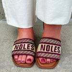 Gold slip-on sandals with garnet “Noles” embroidery and patterned trim