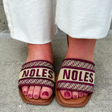 Gold slip-on sandals with garnet “Noles” embroidery and patterned trim