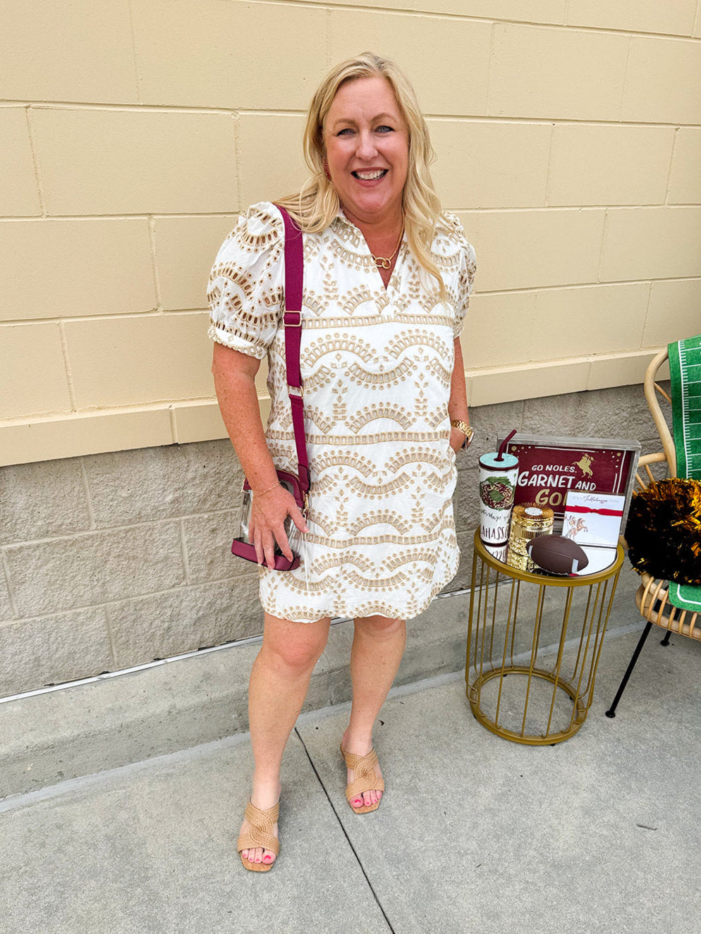 Cream mini dress with taupe geometric eyelet pattern, puffed sleeves, open collar, and side pockets