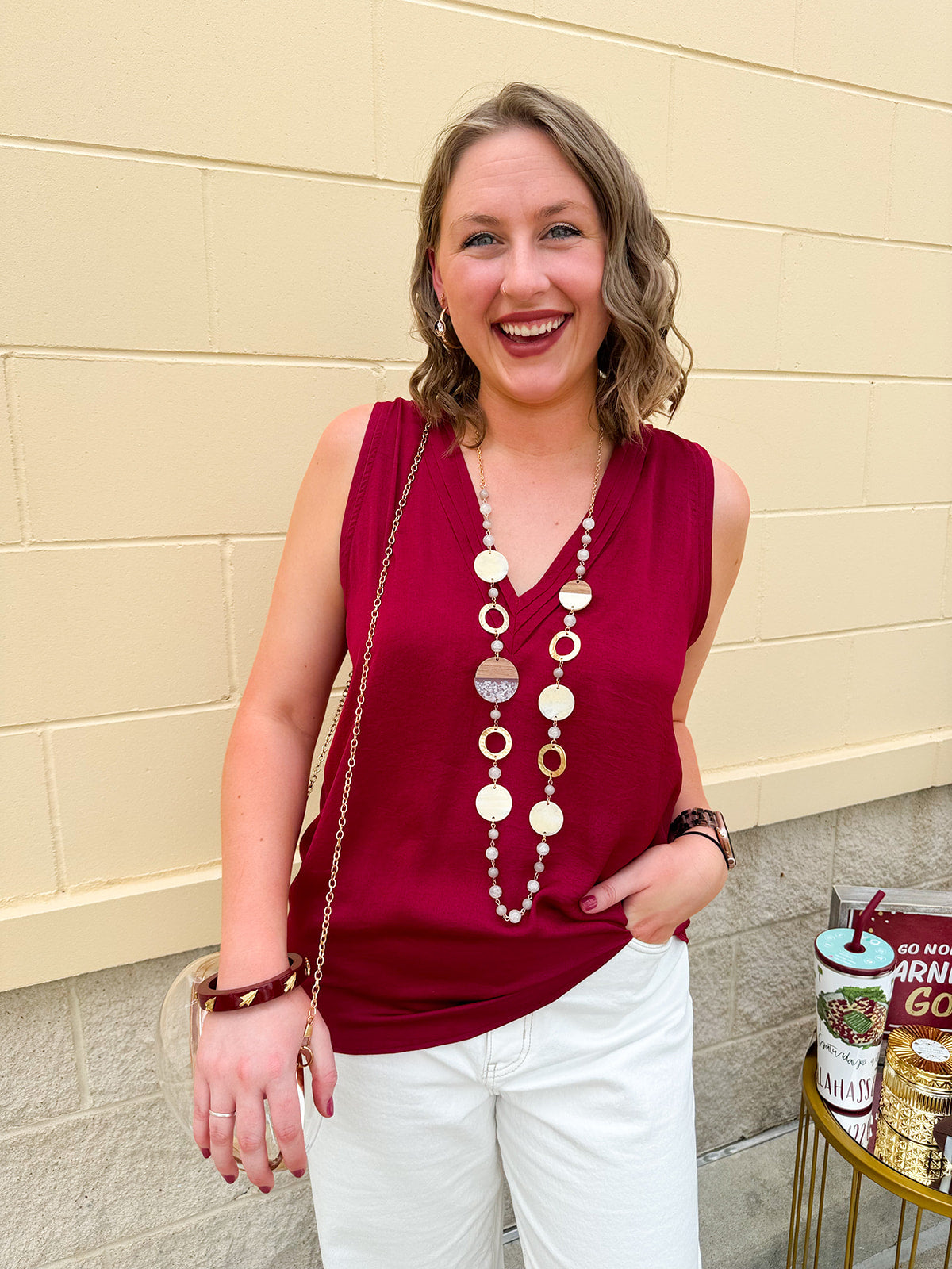 Garnet sleeveless V-neck tank top with pleated neckline detail and a relaxed, lightweight fit—perfect for warm-weather gamedays.