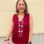 Garnet sleeveless V-neck tank top with pleated neckline detail and a relaxed, lightweight fit—perfect for warm-weather gamedays.