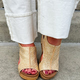 Light gold raffia cork wedges with gold rivets, Velcro heel strap, and a cushioned footbed
