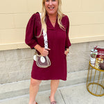 Garnet mini dress with a split U-neckline, flowy fit, and three-quarter peasant sleeves with banded cuffs. Lightweight and perfect for Gameday style.